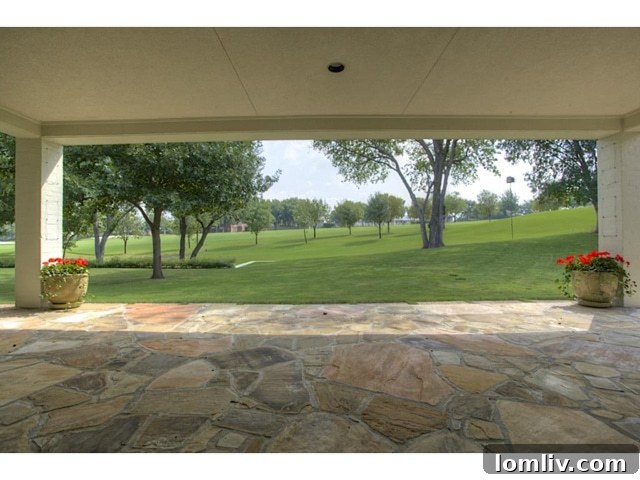 Inviting covered patio overlooking the 8th fairway of Shady Oaks Golf Course, perfect for outdoor living.