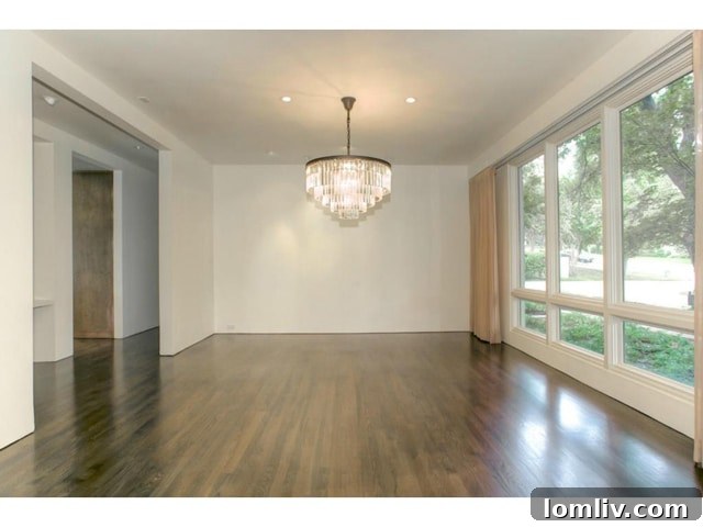 Luxurious formal dining room at 6224 Indian Creek Drive, featuring designer lighting and hardwood floors.
