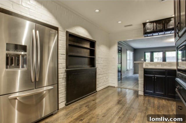 Detailed view of the high-end appliances and stylish cabinetry with glass fronts in the kitchen at 5824 Palm Ln