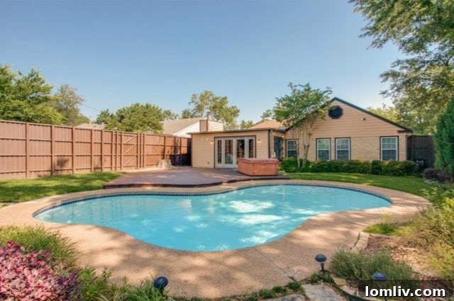 Lush green backyard with a dedicated playhouse, ideal for children and family fun at 5824 Palm Ln