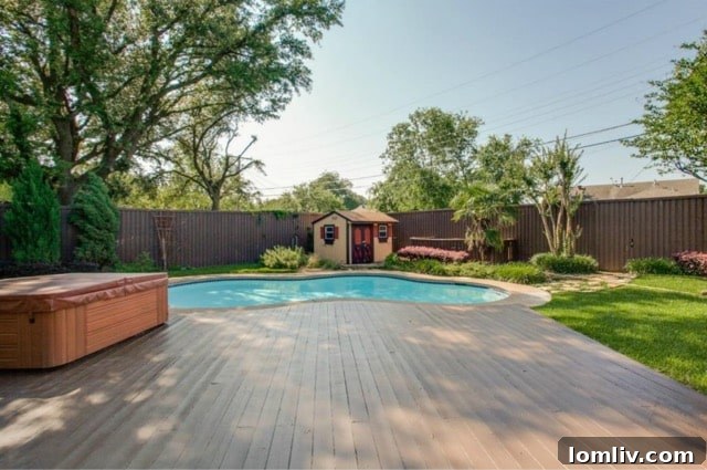 Spacious outdoor living area with a comfortable seating arrangement next to the refreshing pool at 5824 Palm Ln