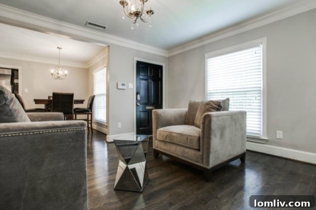 Bright and spacious main living room with gleaming hardwood floors and a cozy fireplace at 5824 Palm Ln