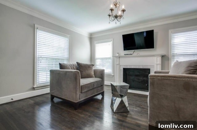 Another view of the sophisticated living space showcasing polished hardwood floors at 5824 Palm Ln