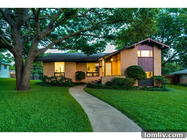 The stunning front facade of 10882 Caprock Circle, a beautifully remodeled mid-century modern home in Dallas's Lochwood neighborhood.