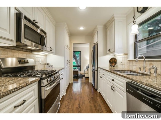 The functional kitchen with granite countertops and updated appliances.