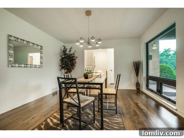 Chic dining area with refinished hardwood floors, ready for intimate dinners or lively gatherings.