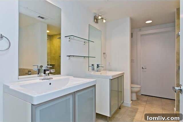 Elegant master bathroom with double vanities and ceramic tile flooring