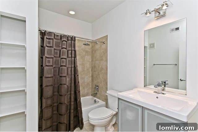 Stylish entry hall with bamboo flooring and a half wall in the Dallas condo