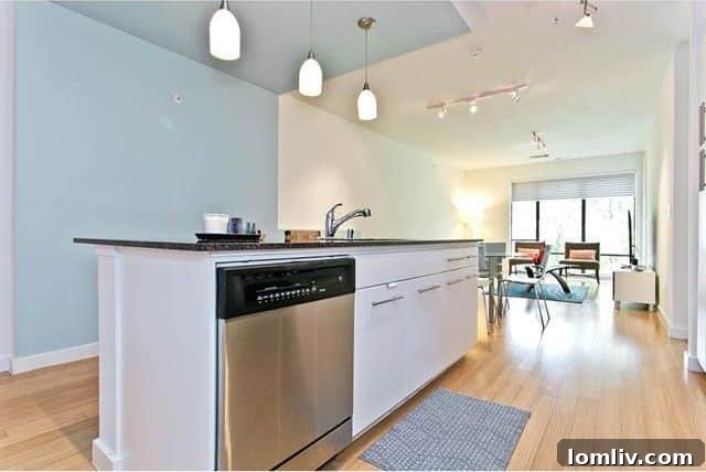 Contemporary pendant lighting over kitchen island in Oak Lawn condo