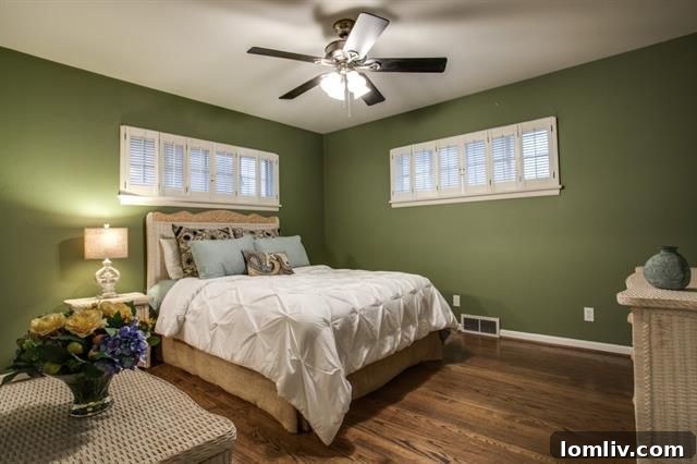 Cozy master bedroom with backyard views and plantation shutters