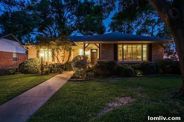 Lush, mature trees surrounding the mid-century home at 703 Kirkwood Dr
