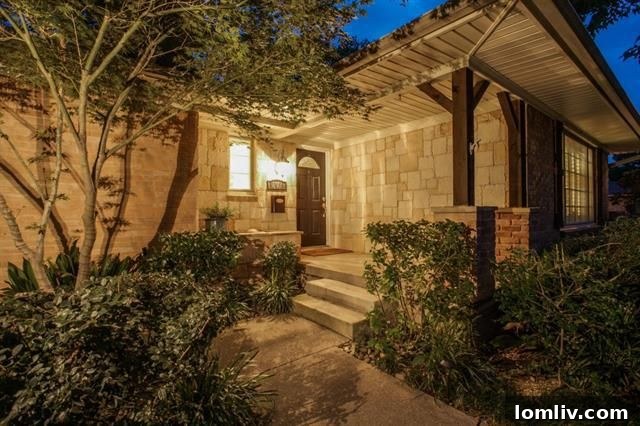 Beautiful landscaping and mature trees enhance the curb appeal of 703 Kirkwood Dr