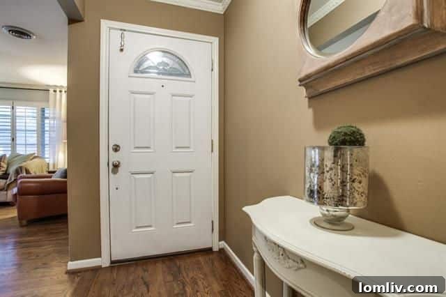 Inviting front porch with stone accents and new wooden columns at 703 Kirkwood Dr