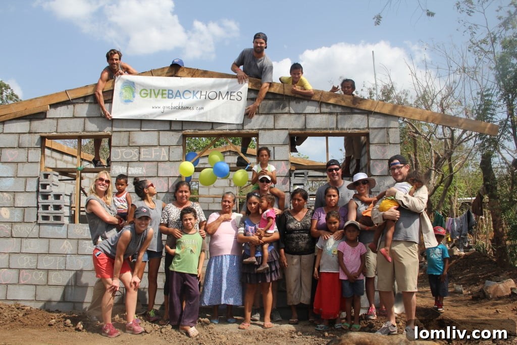 Josefa and her family joyfully posing with the Giveback Homes team in front of their newly constructed home in Nicaragua.