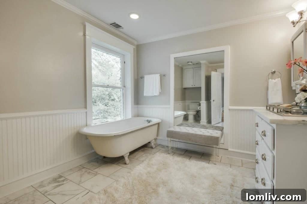 Well-appointed bathroom combining historic charm with modern amenities, featuring stylish tiling and fixtures