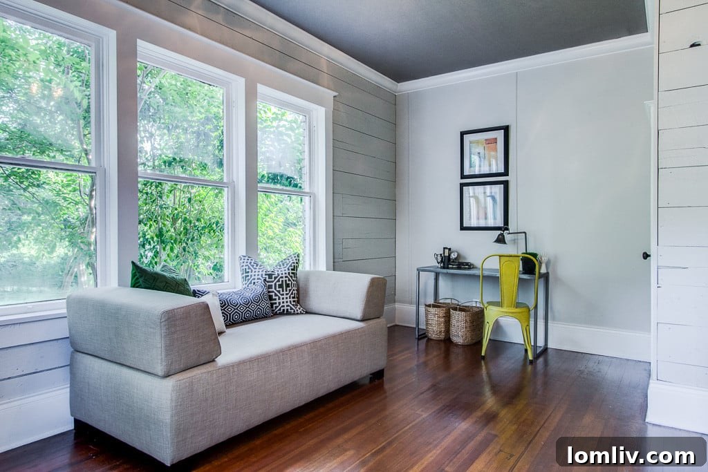 Elegant staircase and hallway featuring original architectural details and rich hardwood flooring