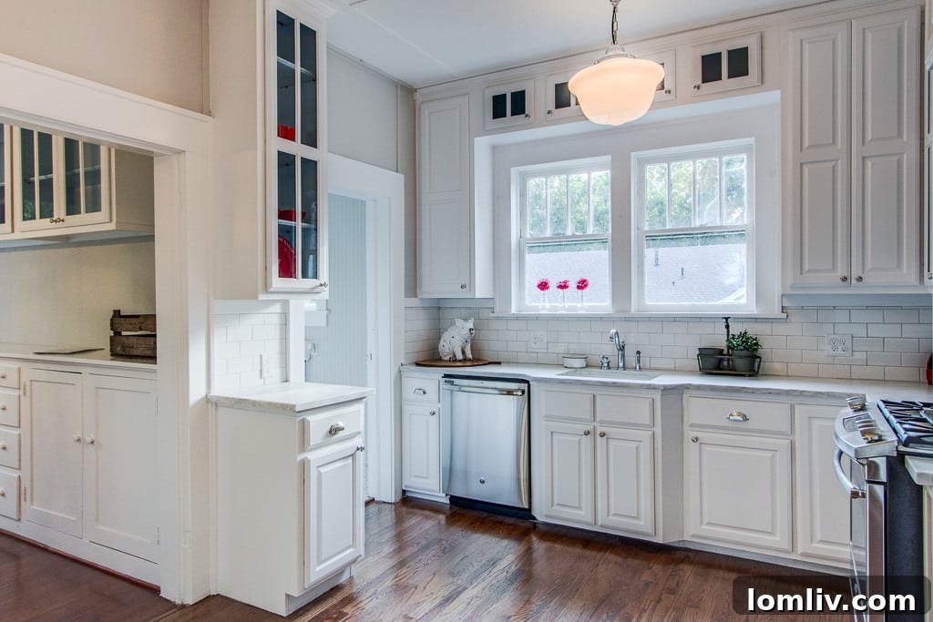Modern kitchen with period-inspired tile, custom cabinetry, and state-of-the-art stainless steel appliances