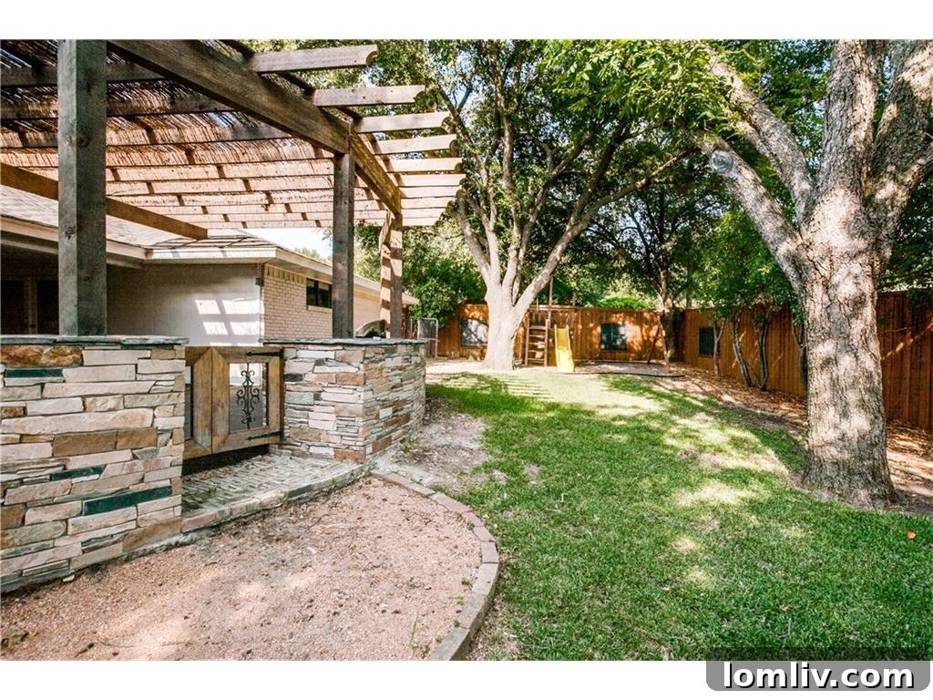 Lush Green Backyard with Mature Trees at 4242 Meadowdale