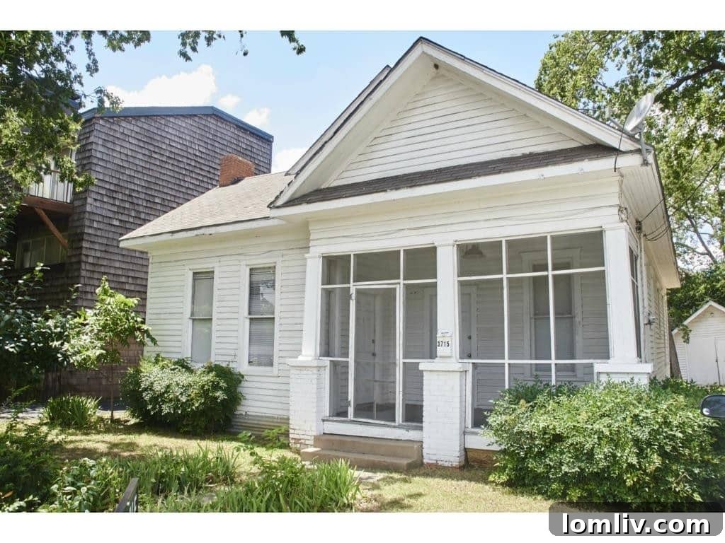 Inviting screened porch of a vintage cottage, ideal for relaxation.
