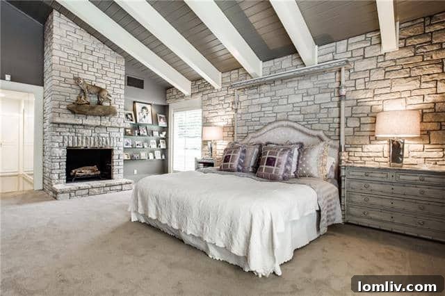 Elegant master bedroom with cozy fireplace, luxurious furnishings, and stunning lake views