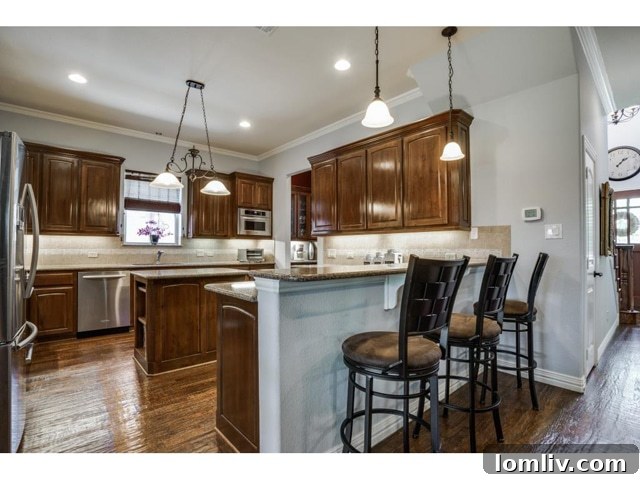 Stainless Steel Appliances and Granite Counters in Kitchen