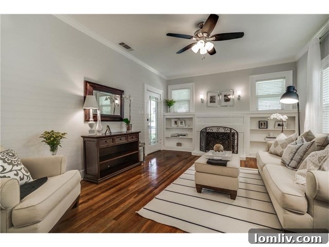 Elegant living room with fireplace and built-ins in a Dallas Tudor home