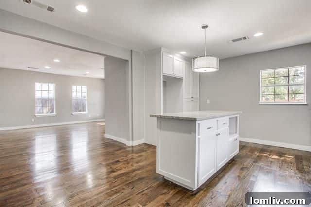Kitchen view highlighting the custom cabinets, gleaming granite countertops, and modern aesthetic.