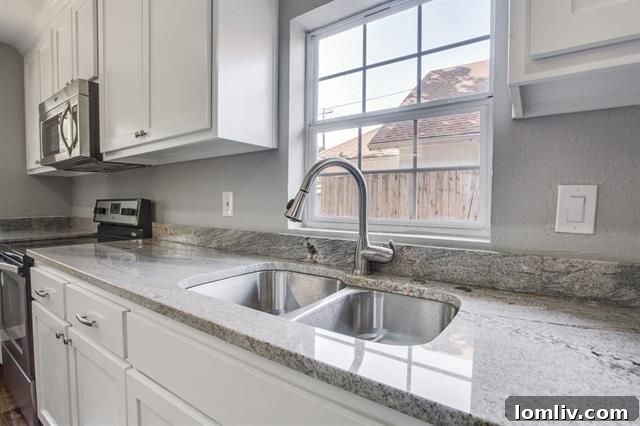 Stylish pendant lighting elegantly suspended over the functional kitchen island.