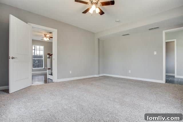 The renovated master bedroom, featuring calming neutral colors, new carpeting, and abundant natural light.