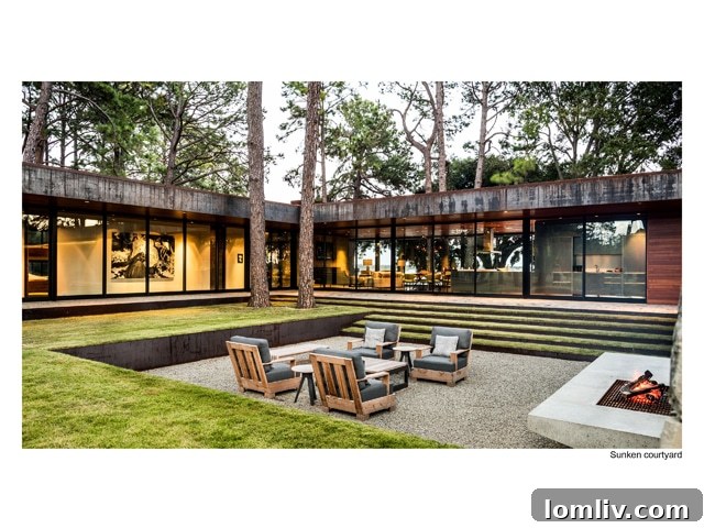 Detailed architectural view of the residence's exterior, emphasizing the interplay of materials like concrete, glass, and wood, against the natural backdrop.