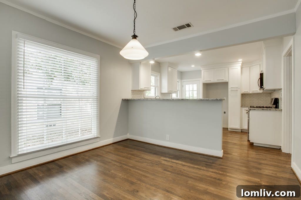 A wider view of the open living and dining spaces.