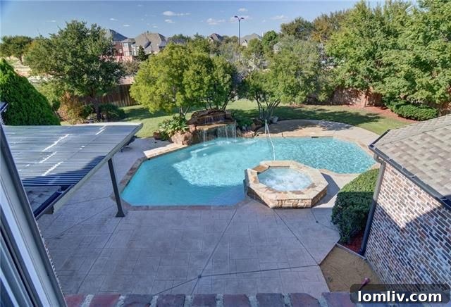 Resort-style backyard with pool, spa, and waterfall at 4800 Northshore Dr.