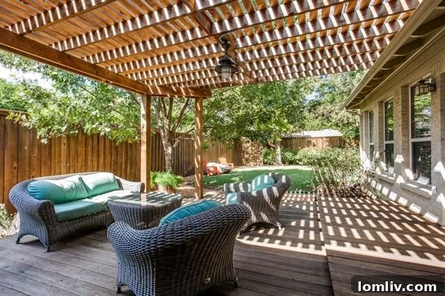 Large backyard deck with pergola, ideal for entertaining at 4135 Saranac Dr.