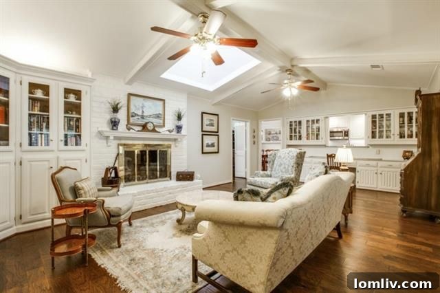Spacious living room with vaulted ceiling and skylight