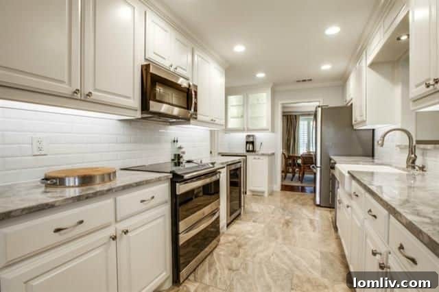 Newly updated kitchen with marble counters and white cabinetry