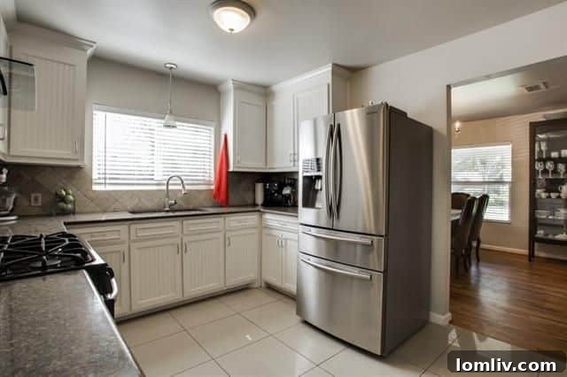 Updated kitchen with stainless steel appliances and granite counters