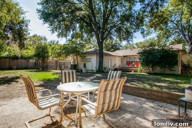Spacious backyard with mature trees and wood deck