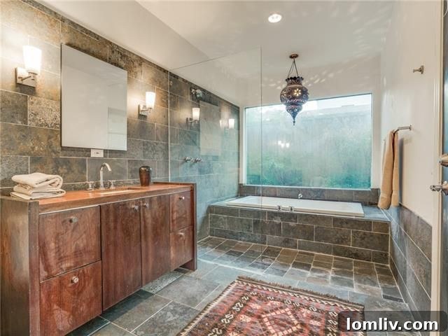 Master bathroom with slate floors and soaker tub in the updated bungalow