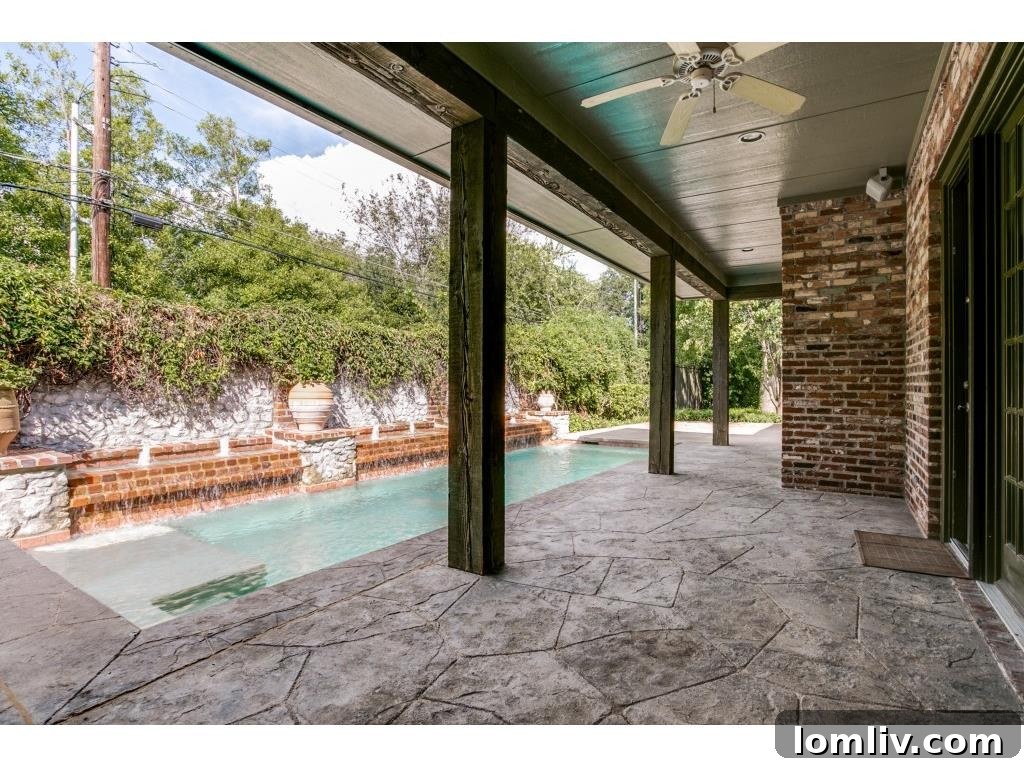 Lush backyard with covered patio and seating area, ideal for outdoor relaxation