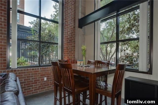 Loft with Two-Story Windows Overlooking Courtyard