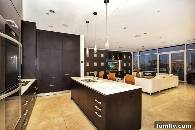 Modern open-concept kitchen and living area with city views