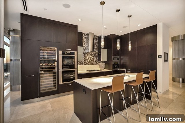 High-end kitchen with integrated appliances and large wine fridge