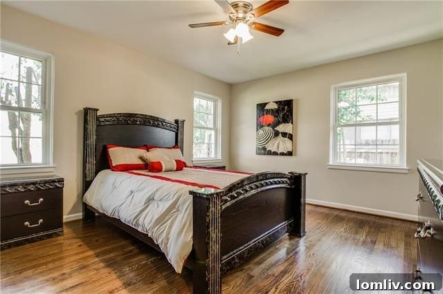 Spacious bonus room with a rustic wood ceiling, double glass doors, and ample natural light from backyard-facing windows.