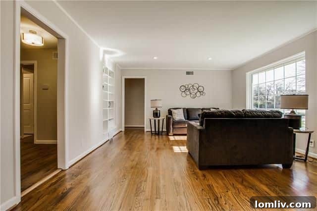 Interior view showcasing the continuous hardwood flooring and general flow of the main living areas.
