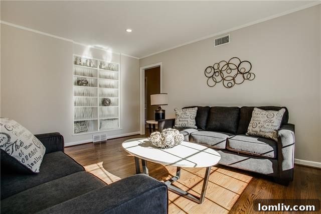 View of the living room connecting to the dining area, emphasizing the open floor plan and natural light.