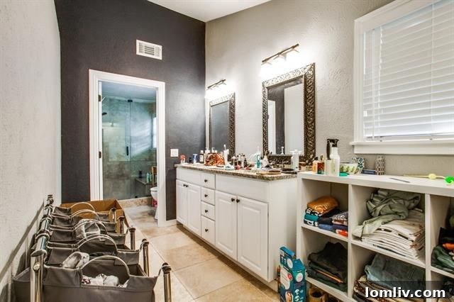 Master bathroom with dual sinks and granite countertops