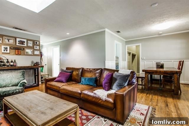 Spacious living room featuring a large skylight