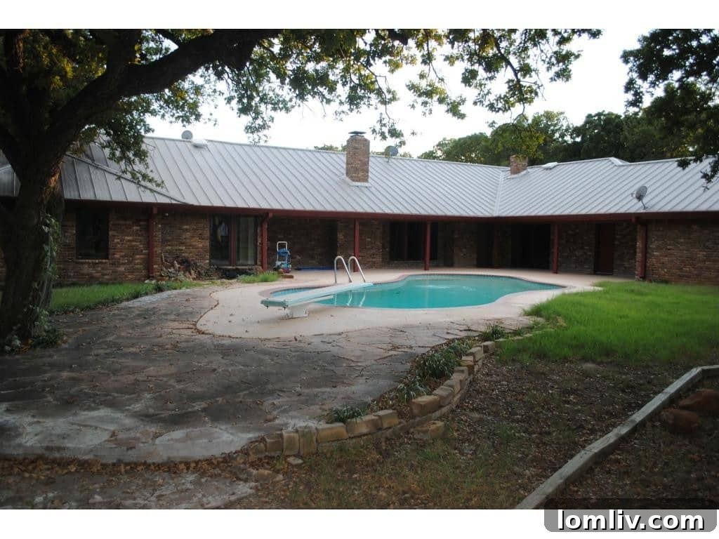 Aerial view showing the pool and surrounding grounds, giving a sense of the property's scale.