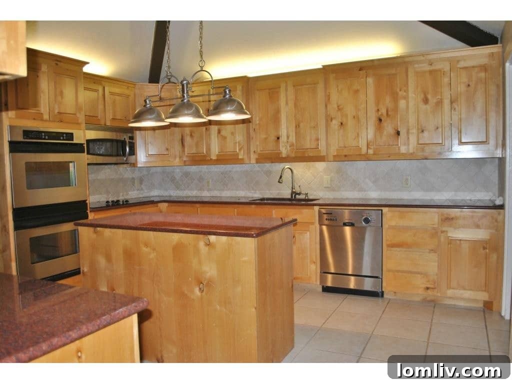 Modern kitchen with high-end stainless steel appliances and custom cabinets in the Couch home.