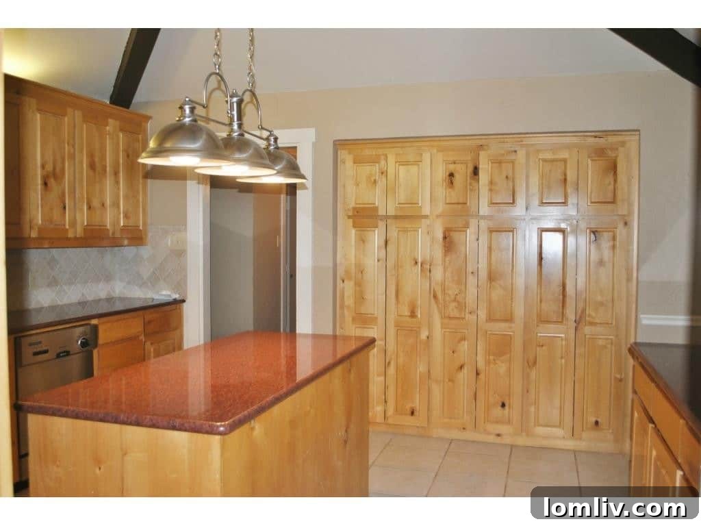 Another view of the spacious kitchen with custom Knotty Alder cabinetry and granite countertops.